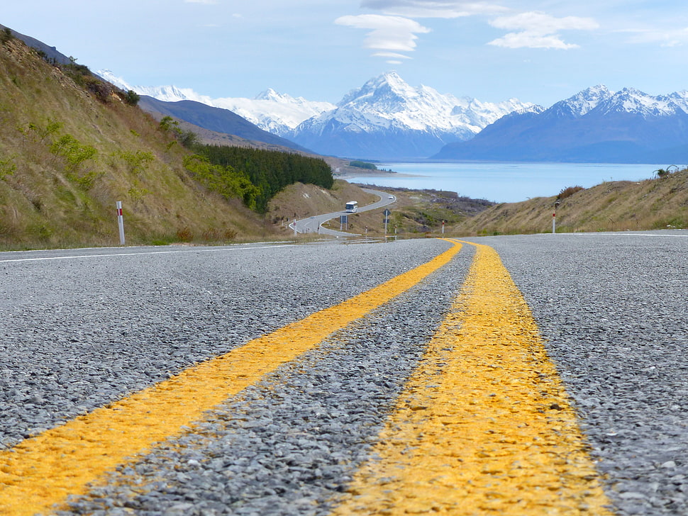 landscape photography of wining road leading to snowy mountain during daytime, mount cook, nz HD wallpaper