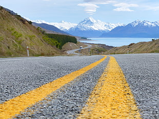 landscape photography of wining road leading to snowy mountain during daytime, mount cook, nz