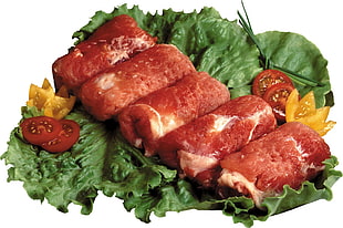 five rolled meat with green veggies and sliced tomato