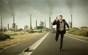 man in black formal attire running from pollution during daytime