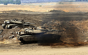 photography of two battle tanks on ground