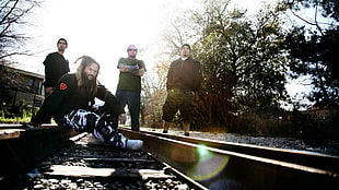 closeup photography of music band standing on train railways