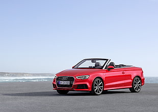 red Audi convertible coupe during daytime