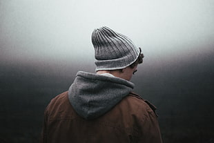 man wearing gray knit cap and brown hoodie