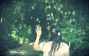 woman wearing beige shirt and bubbles