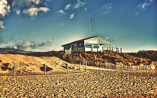 wooden house at the sand dunes under cloudy day