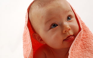 baby wearing orange towel