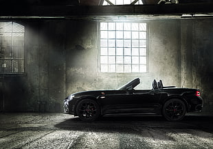 black convertible car in garage with sunlight from window