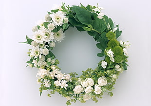 white and green floral wreath on white surface
