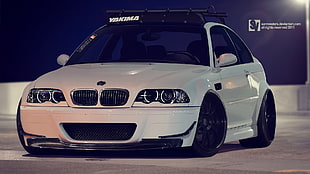 white BMW E46 M3 coupe on black top road