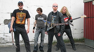 metal band holding electric guitars