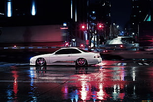 white coupe on wet road during night time