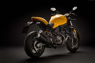 photo of black and yellow naked motorcycle