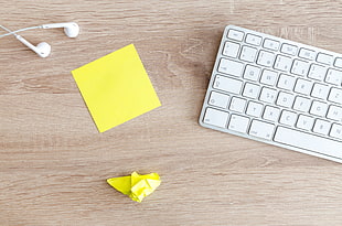 photo of crumpled yellow paper near Apple Magic keyboard