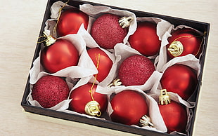 closeup photo of twelve red baubles in box