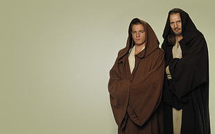 two person wearing brown and black hoodies