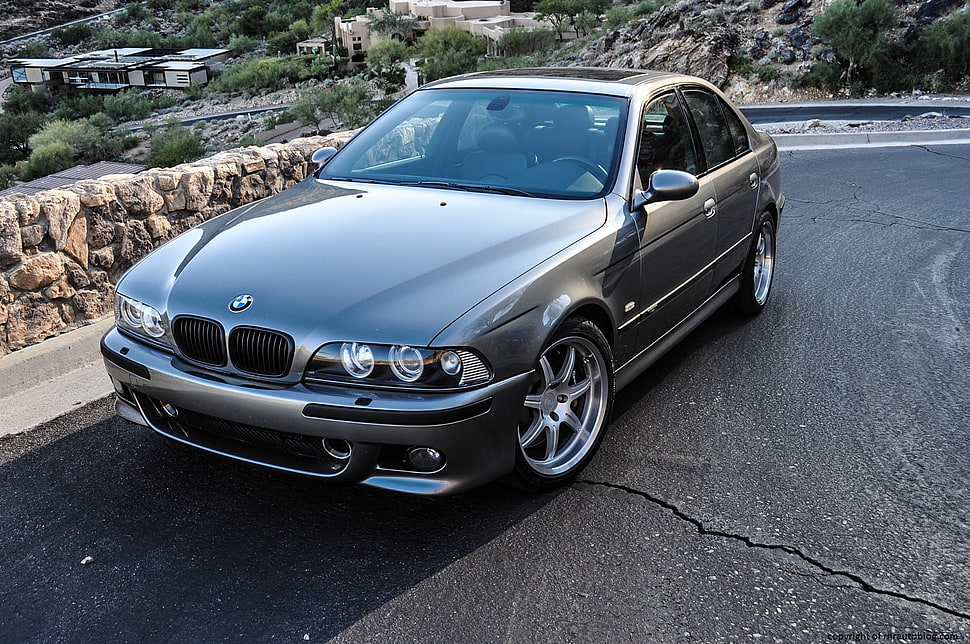 gray BMW sedan on gray concrete road HD wallpaper