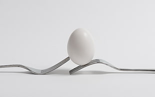 white egg on top of stainless steel fork