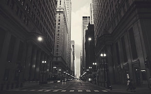 grayscale photography of road in between buildings