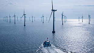 wind mills on the ocean during daytime