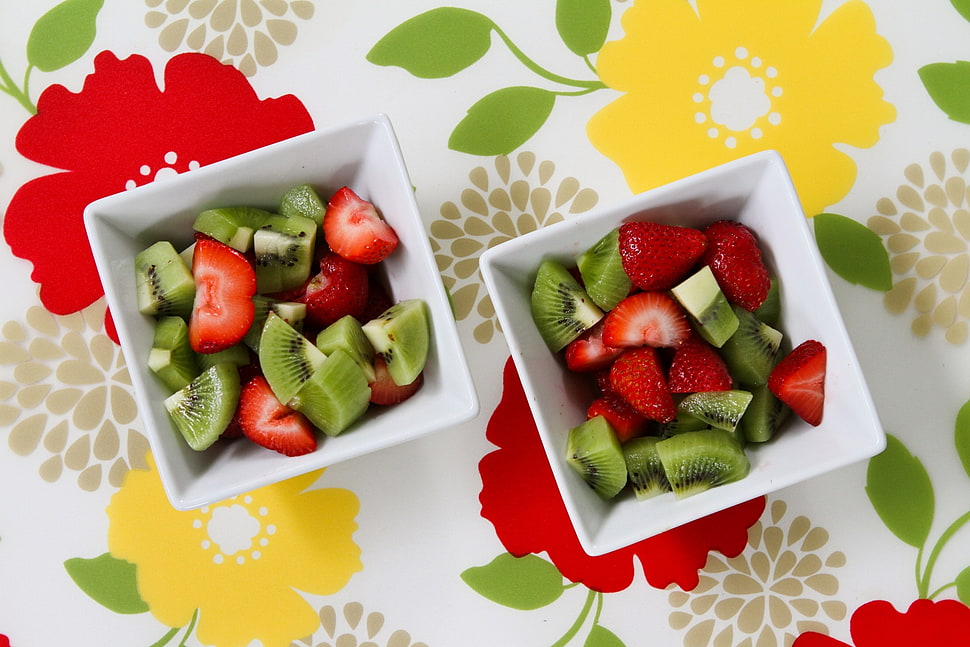 two bowls of sliced strawberries and kiwi fruits HD wallpaper