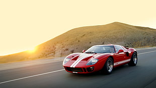 red and white sports car near mountain during golden hour HD wallpaper