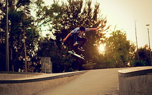 man in black jeans riding skateboard during daytime