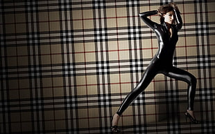 woman with latex suit in burberry background