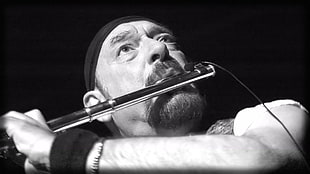 grayscale photo of man playing flute HD wallpaper