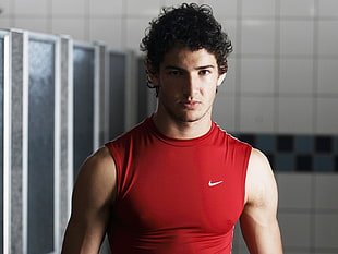 man wearing red Nike tank top