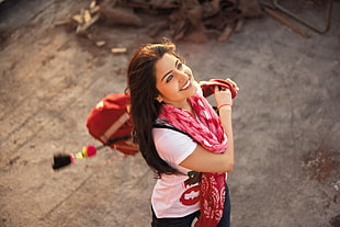 smiling woman wearing pink t-shirt and scarf