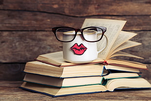 white and pink ceramic mug, photography, books, cup, glasses