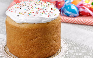 baked cake with frosting and candy spinkles