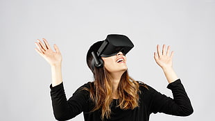 female wearing black long-sleeved top and black VR goggle