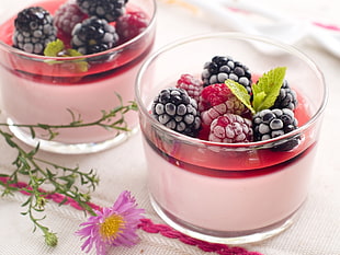 blueberry and raspberry in clear glasses