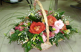 brown wicker basket with red and pink Roses
