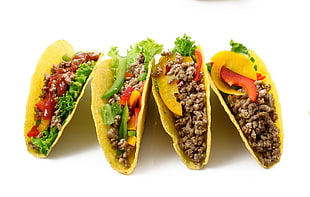 four tacos on white background