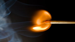 shallow photo of a lighted match stick