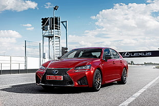 red Lexus sedan on gray concrete road