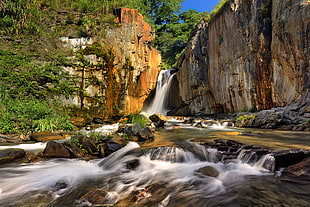 waterfalls near cliff during daytime