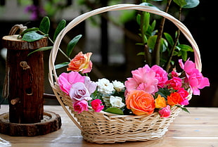 assorted petaled flowers on beige wicker basket