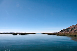 landscape photography of mountain and body of water, lake titicaca