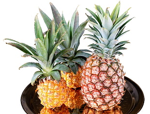 three pineapples on black tray