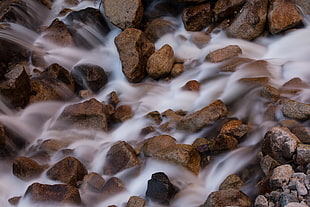 brown and gray rocks with running water, machu picchu