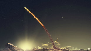 meteor above cloudy sky