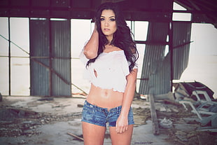 woman in white crop shirt and blue denim hot shorts
