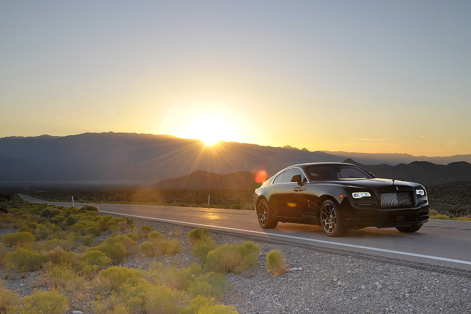 Black coupe on asphalt road HD wallpaper