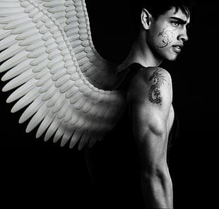 black and white photography of man with wings
