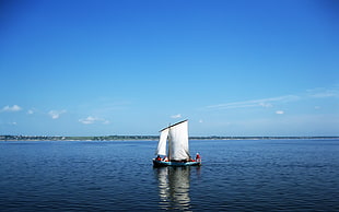 white sailboat on the middle of the ocean during daytime