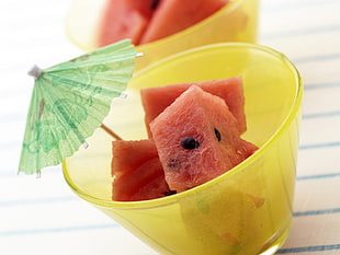 closeup photography of slice of watermelon in yellow tinted glass cup
